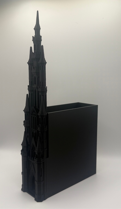 A black gothic cathedral tower desk organizer with a rectangular black insert, photographed on a light gray studio background.